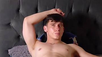 A naked Latino guy lies spread out on his bed, showing off his ass and ready for action. He plays with himself in his bedroom, putting on a horny solo show just for you.
