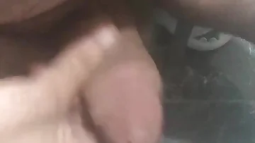 Close-up of a chubby guy jerking off just for your pleasure. He works his cock with enthusiastic strokes until he erupts.