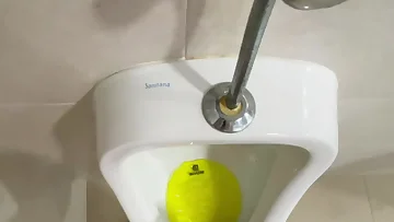 This European guy pisses naked at a public urinal in this homemade footage. He doesn't hold back as he unleashes his stream in this daring solo act.