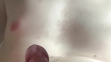 Stroking my small hairy cock slowly on the bed. This homemade solo masturbation captures every intimate detail up close.