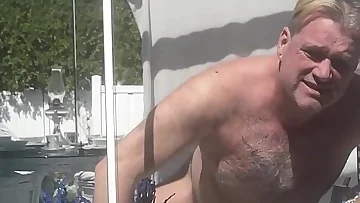 A bear stepdaddy sunbathes naked before jerking off for everyone to see. His outdoor masturbation session ends with a massive cumshot under the sun.