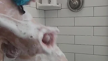 He gets oiled up in the bathroom and starts stroking his big shaved cock. The amateur solo session shows off every inch of that massive dick.
