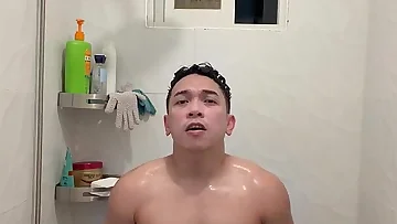 A muscular Filipino twink jerks off in a steamy shower scene, building toward a satisfying cumshot. This amateur Asian performer combines BDSM elements with his masturbation routine.