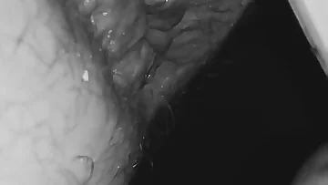 He's absolutely wrecking his swollen ass with some intense toy action. The close-up view shows just how much punishment his hairy hole can take.