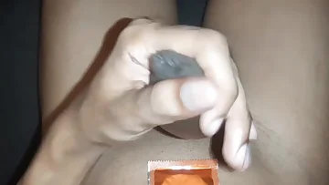 A Desi boy jerks off with a condom stretched over his uncut cock. He works his covered dick with intense rhythm, showing how even protected masturbation can be fucking hot.