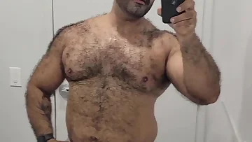 A solo hairy guy proudly displays his thick bush and hard dick in this homemade video. He gives you an intimate look at his personal jerk-off session.
