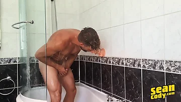 In the bathroom, Jake strokes his uncut cock until he cums, making a mess with his thick load. That hunk's big dick pulses as he unleashes his pent-up release.