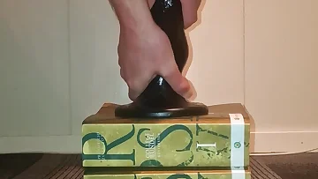 He's stretching his tight ass open with a massive dildo, moaning with each inch. This anal toy session shows his feet curling in pleasure as he takes every bit of that huge toy.
