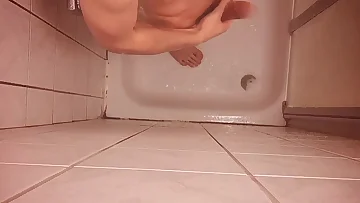 This twink is showering and playing with his young cock in the bathroom. His amateur solo session shows off his smooth body perfectly.