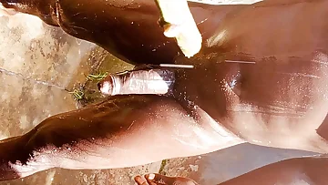 Sunlight beautifully highlights his dark skin as he strokes his hard cock outdoors. This straight guy enjoys some solo time in nature, showing off his homemade skills.
